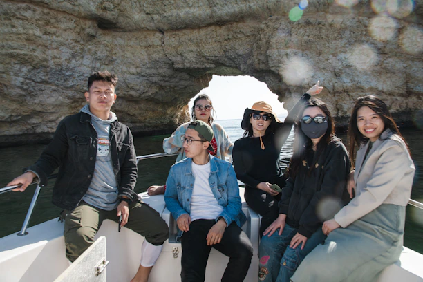 A group of friends smiling on a boat tour around Komodo Island.