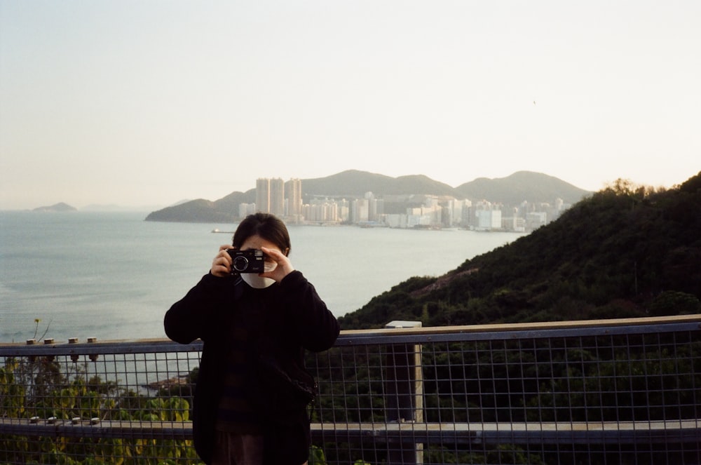 a person taking a picture of a body of water