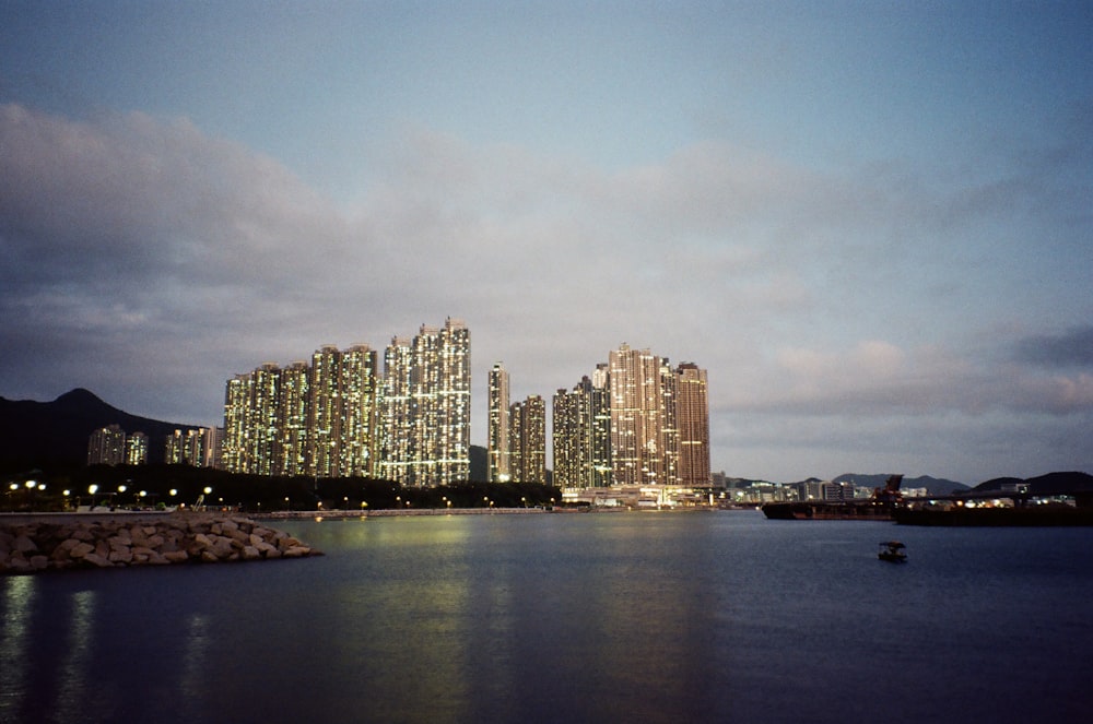 a large body of water with a city in the background