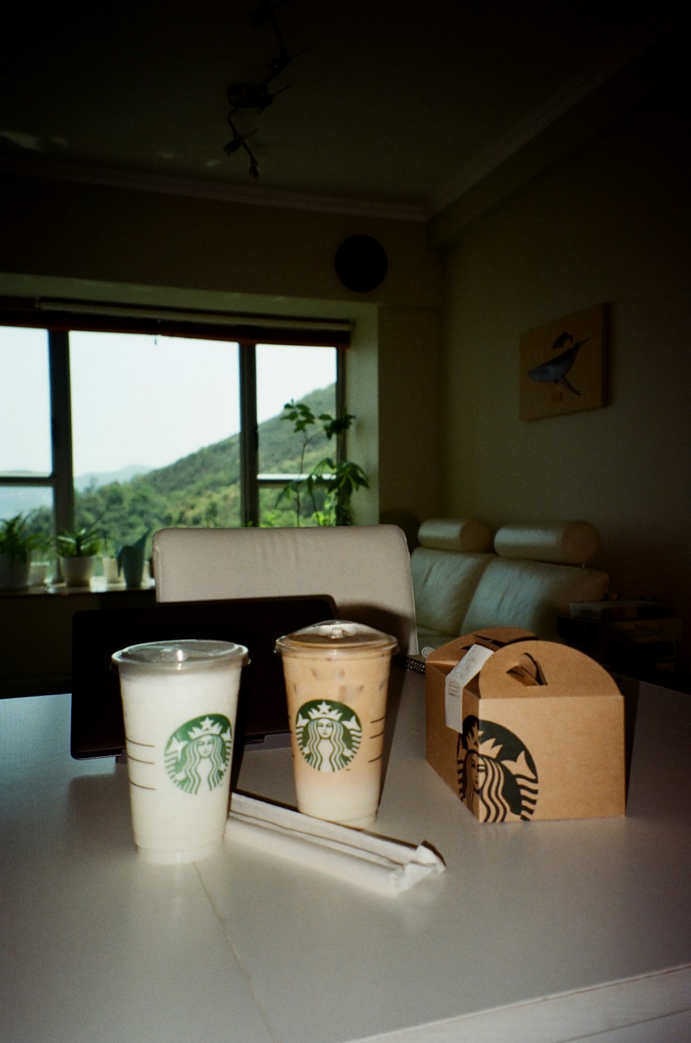 a table with two cups and a box on it