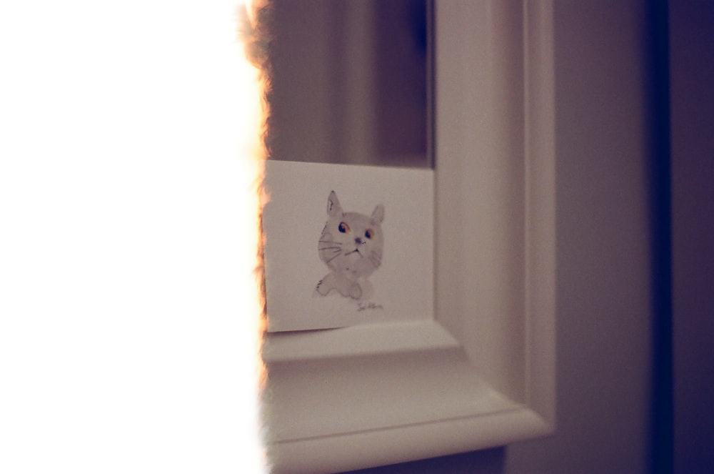 a picture of a cat on a window sill