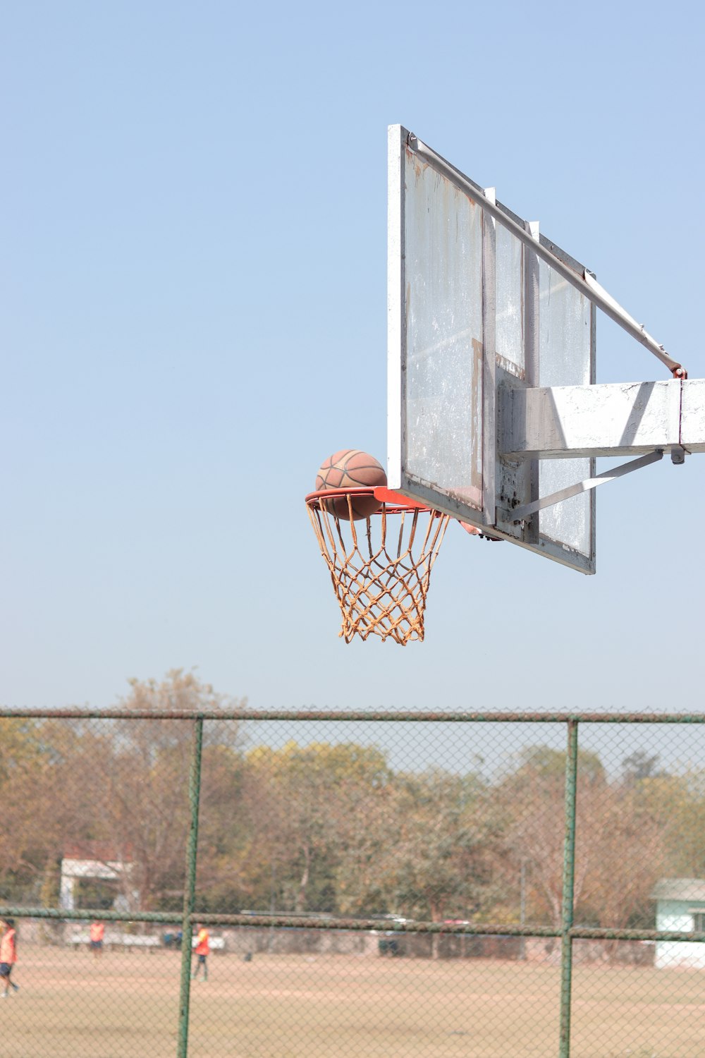 a basketball going through the hoop on a basketball court