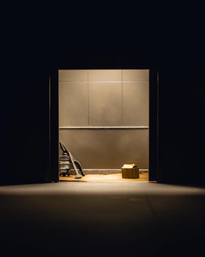 Cleaners thoroughly cleaning an empty apartment after a move, with boxes in the background.