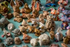 a table topped with lots of small figurines of animals