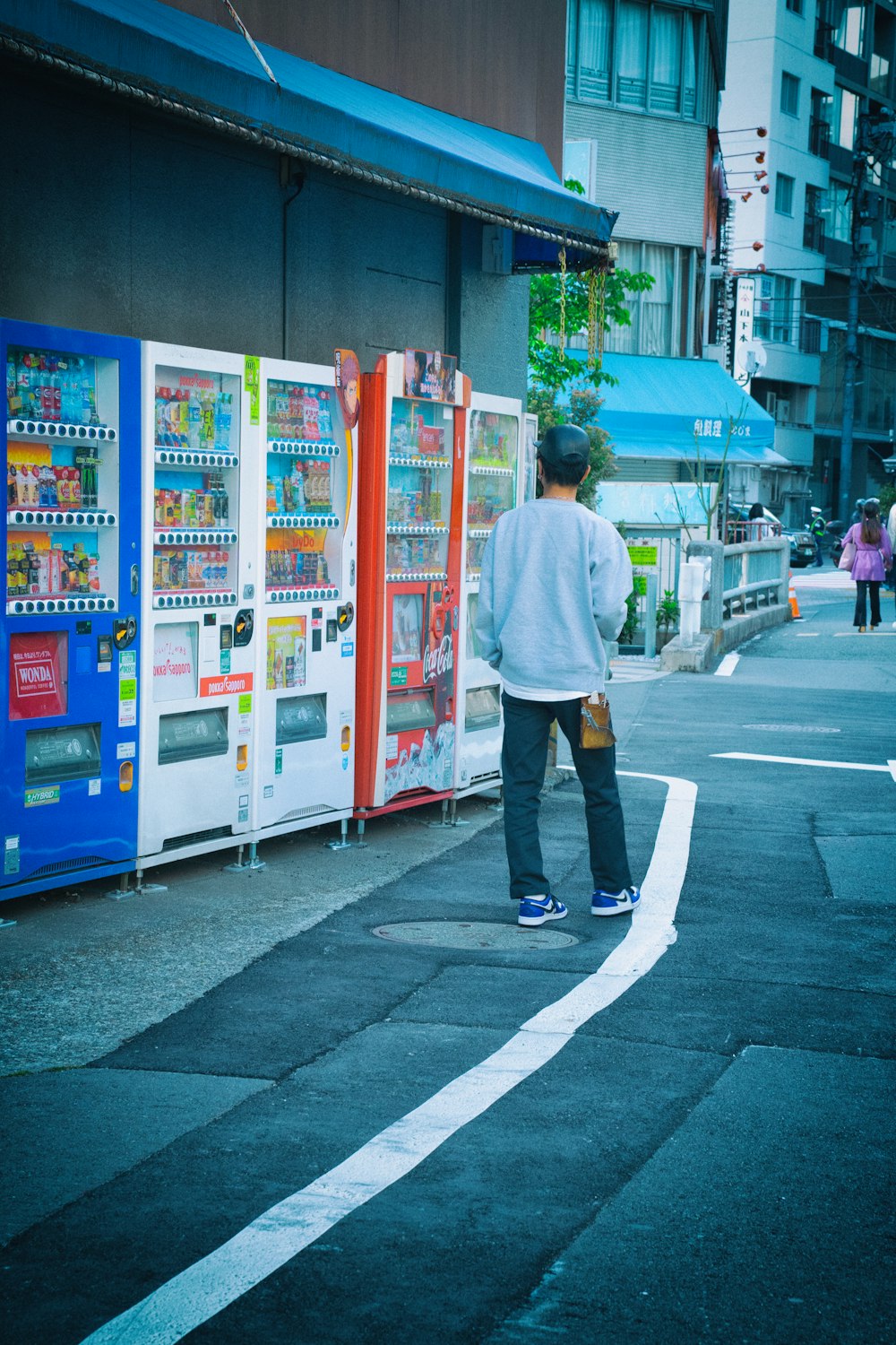 a man standing in front of a vending machine