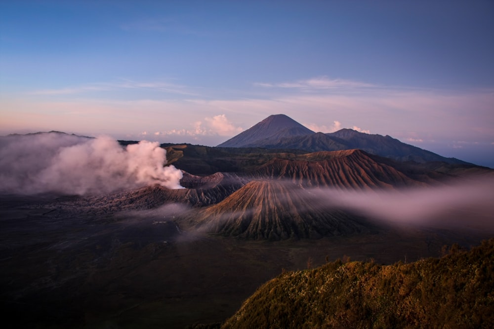 a view of a mountain covered in clouds