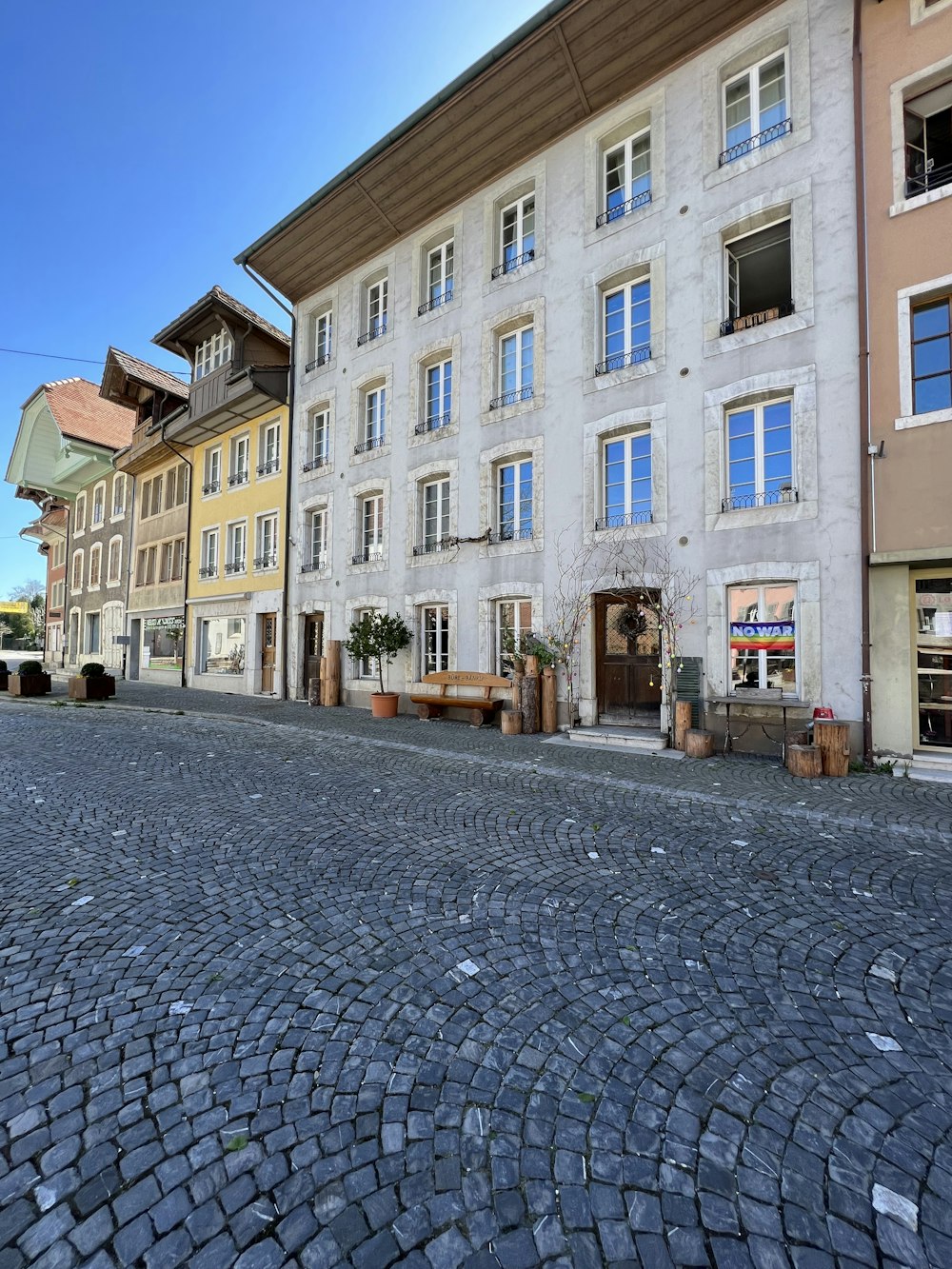 a cobblestone street lined with tall buildings