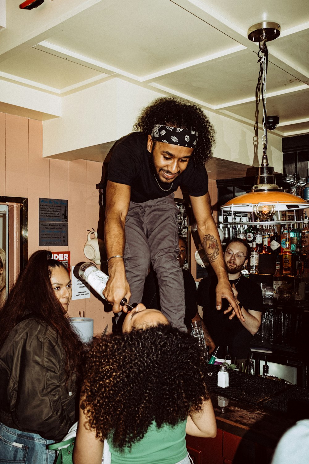 a man standing on top of a woman's head