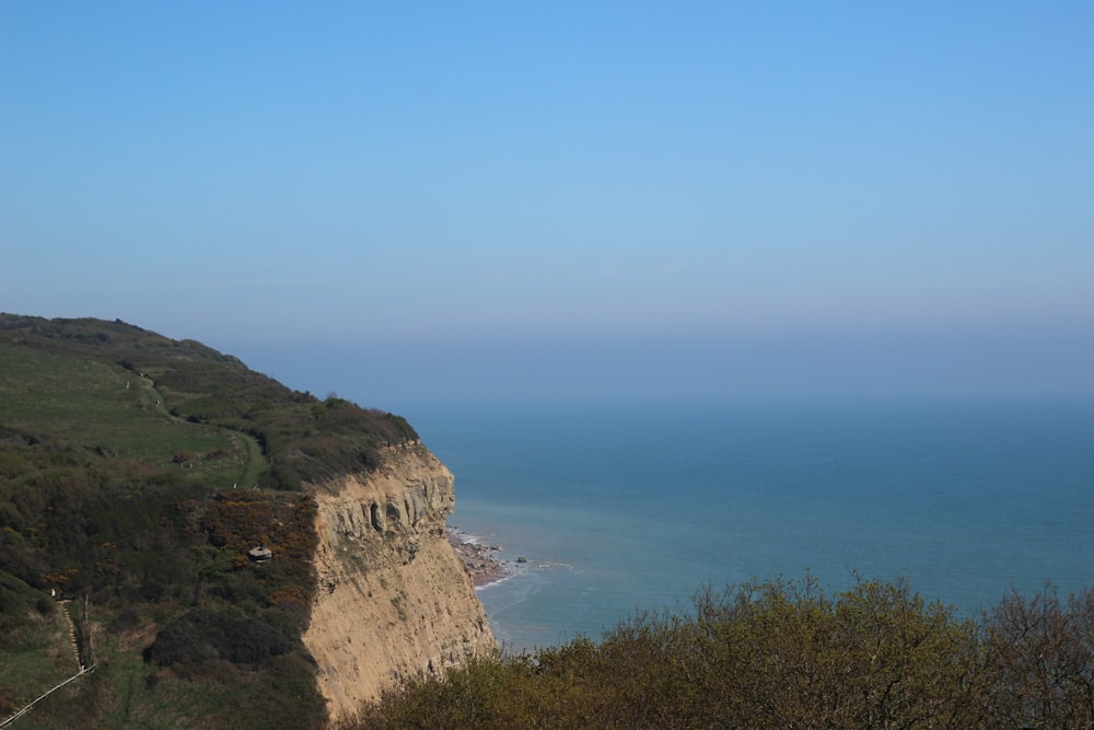 a view of the ocean from the top of a hill