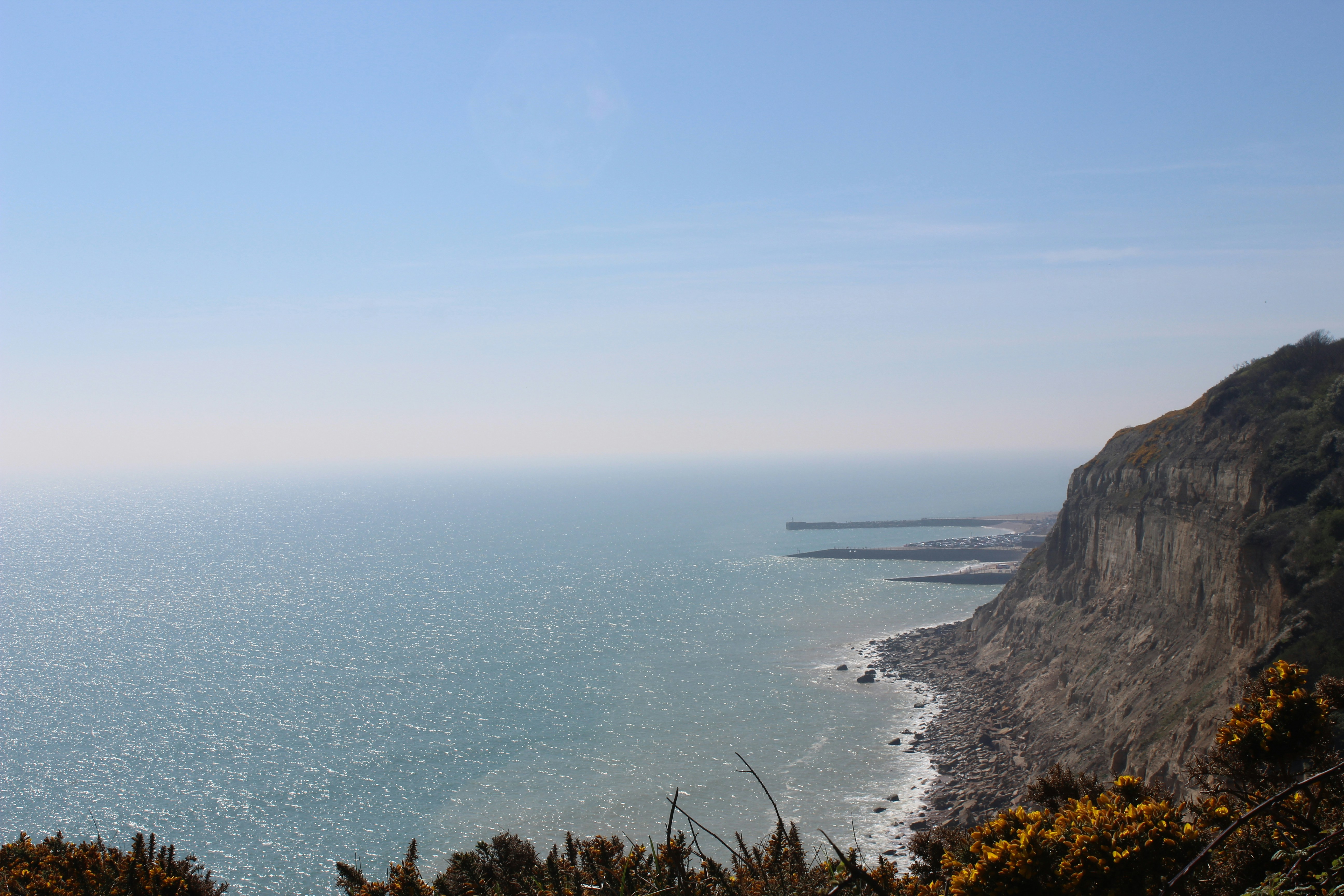 a view of the ocean from the top of a hill