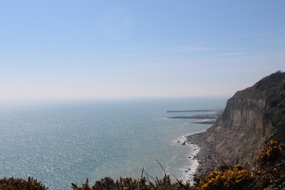 a view of the ocean from the top of a hill