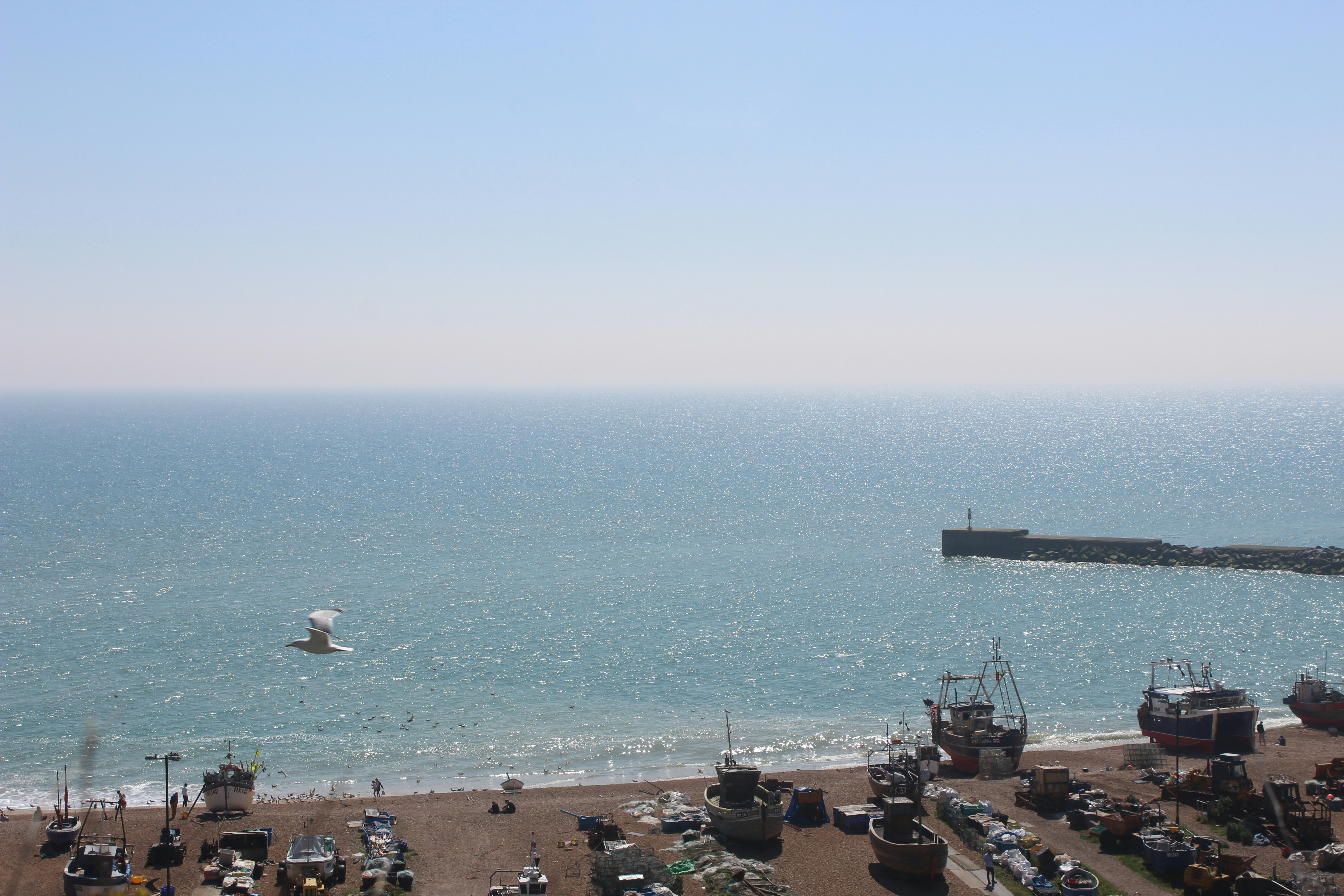 a large body of water next to a sandy beach