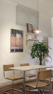 A minimalist dining area with a wooden table and contemporary chairs