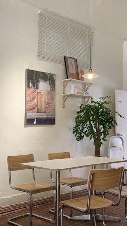 Dining area with minimalist wooden table surrounded by chairs