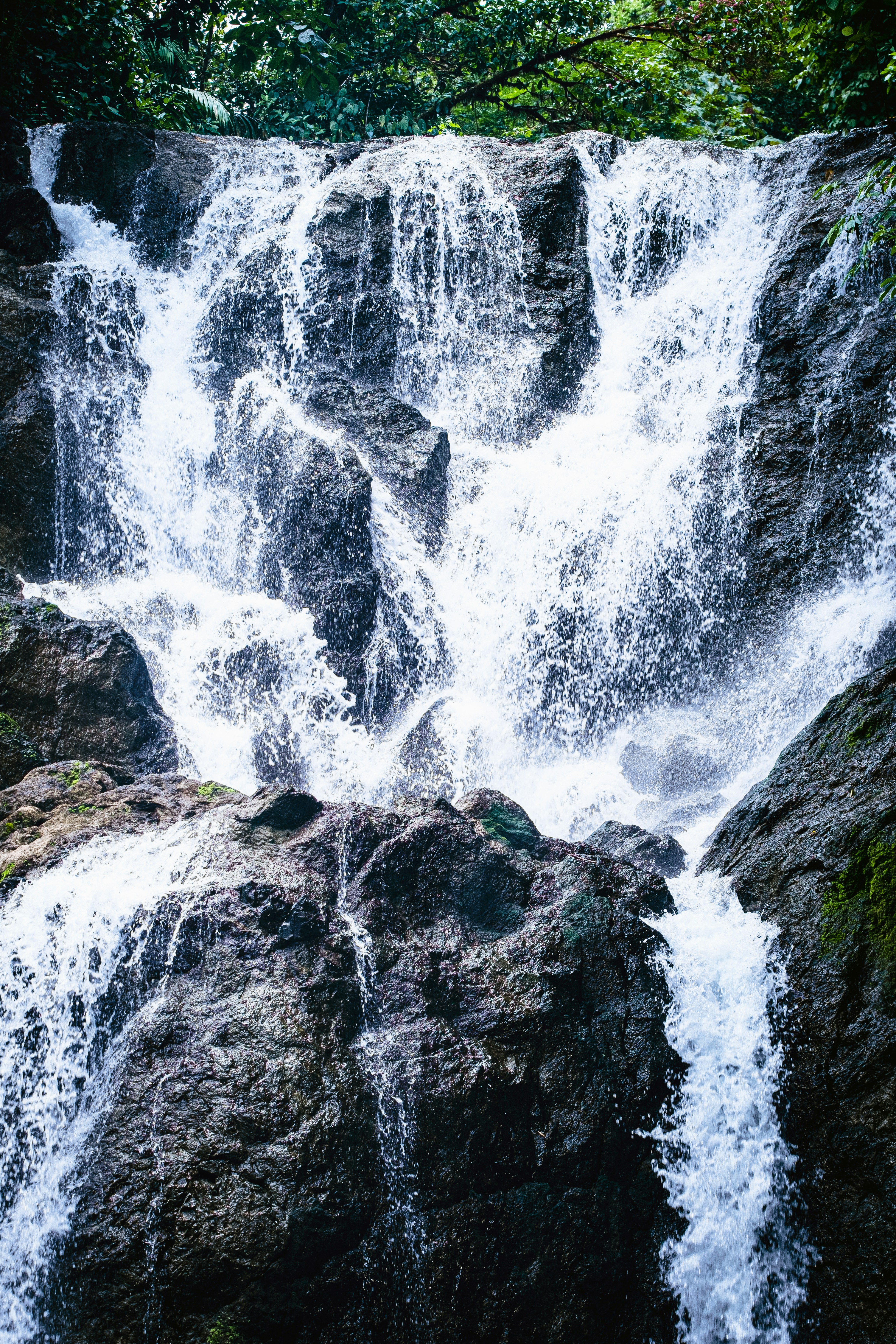 a large waterfall over some water