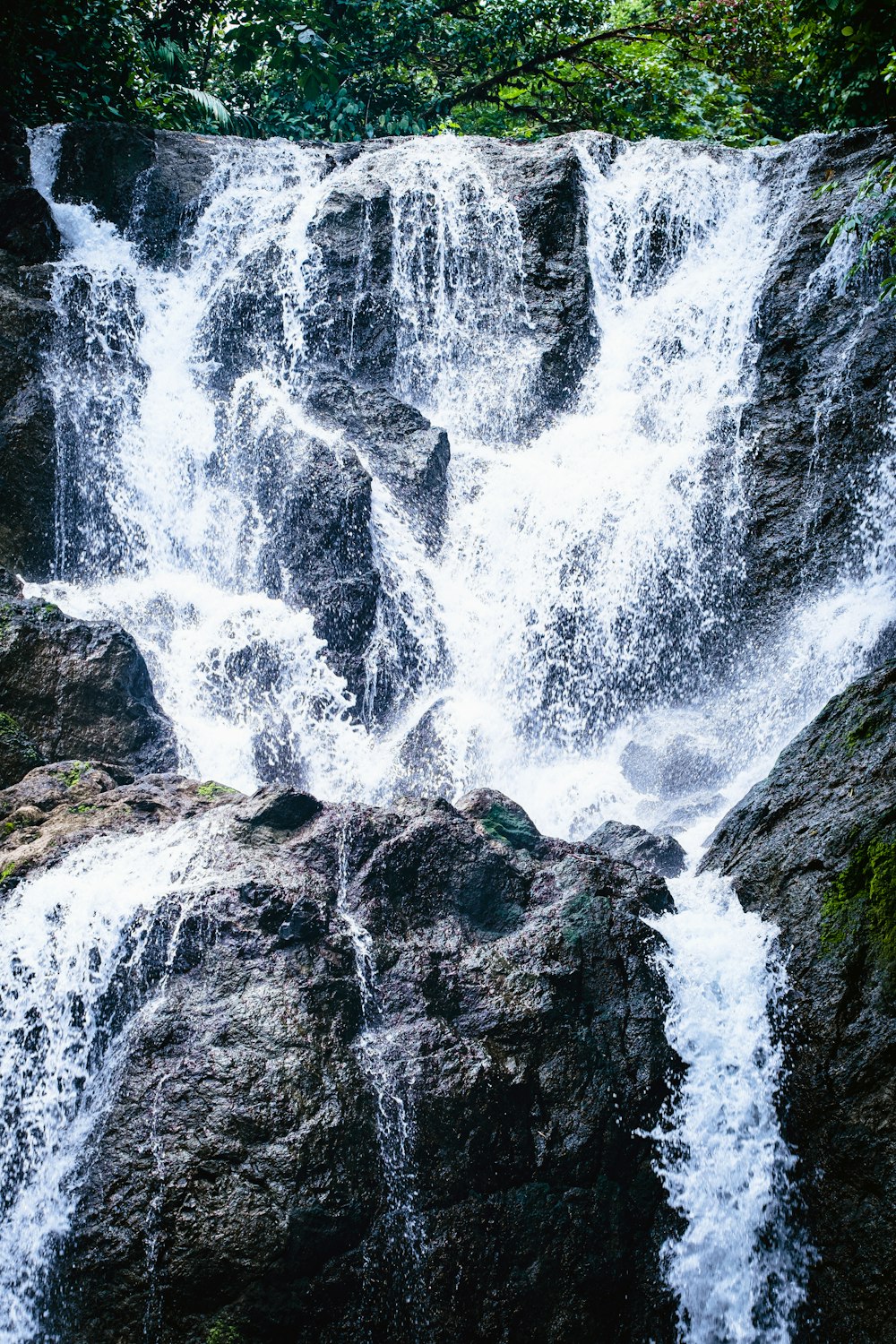 a large waterfall over some water