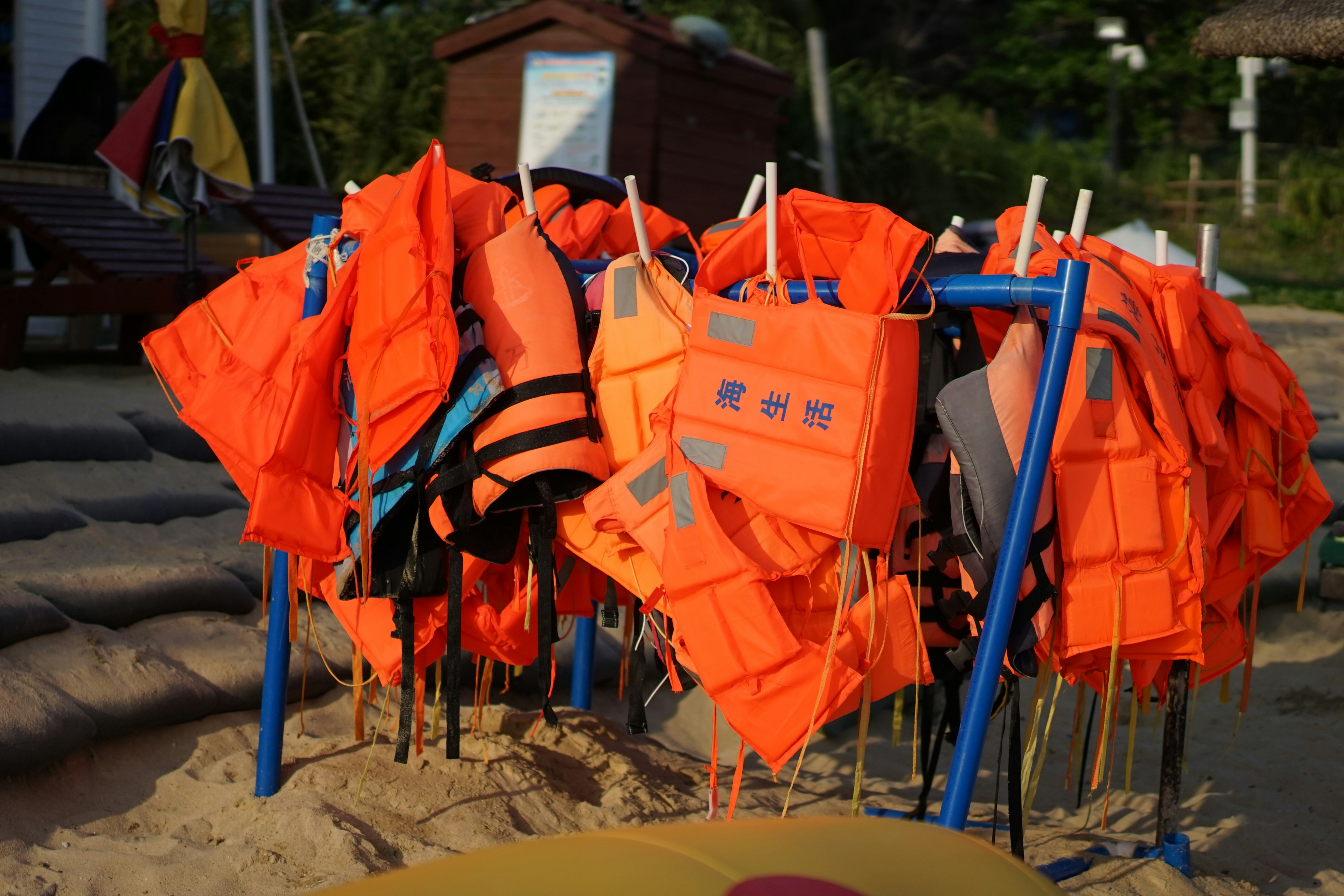 Orange life vests and life vests on a beach photo Free Beach Image on