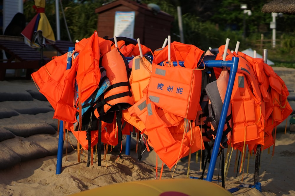 orange life vests and life vests on a beach
