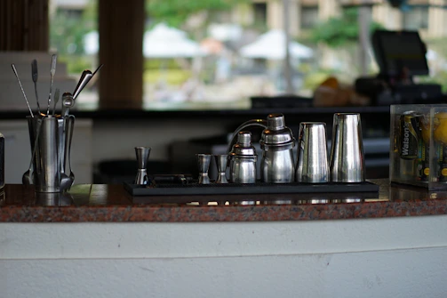Finished set of bar accessories displayed on a rustic wooden surface.