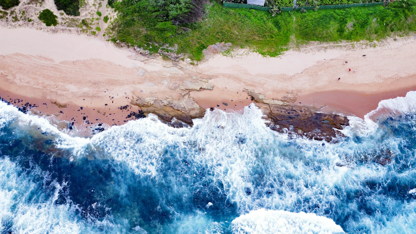 Overhead view of surf breaking over the rock shelf onto Umdloti beach