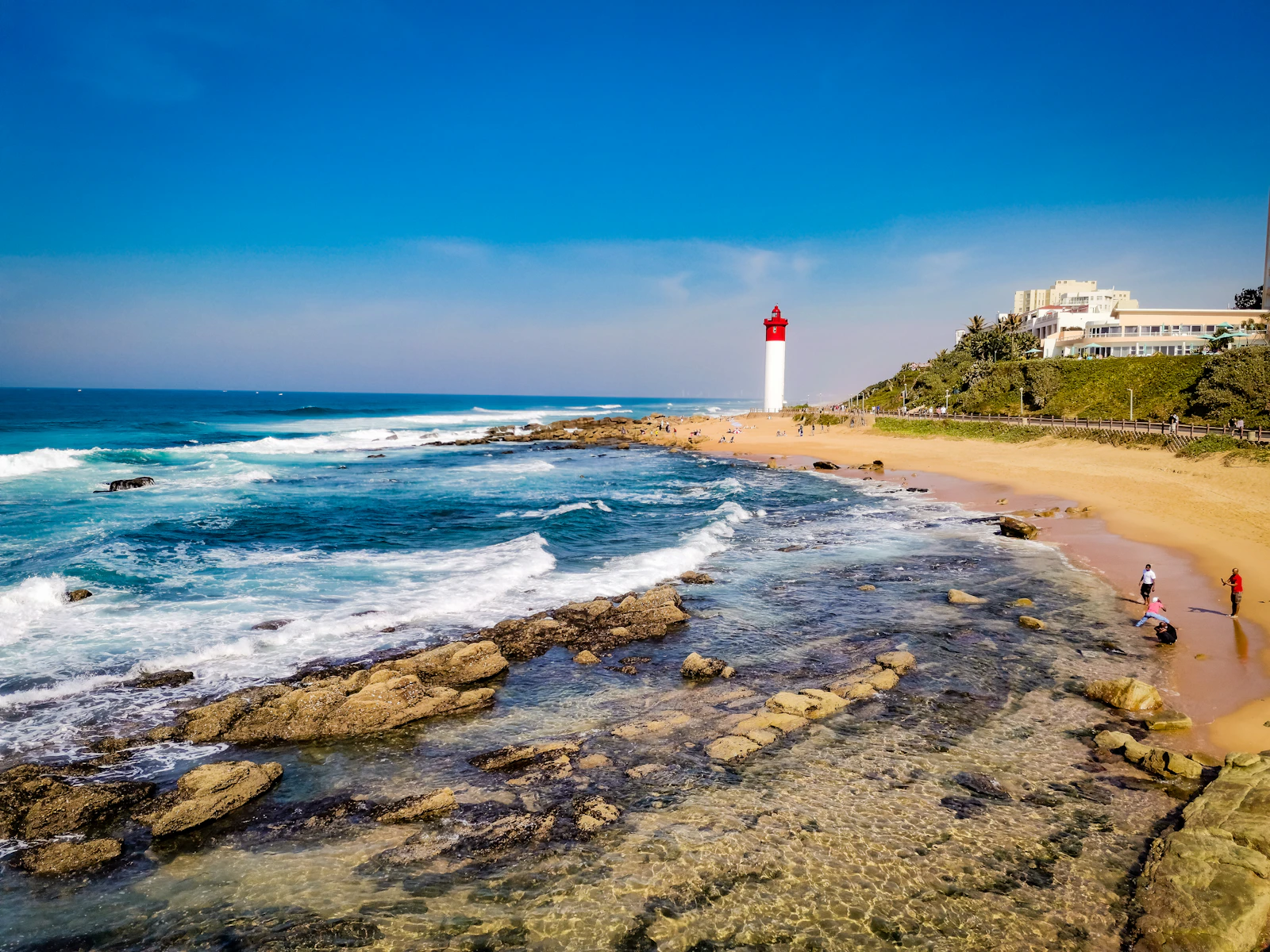 A beach with a light house in the background