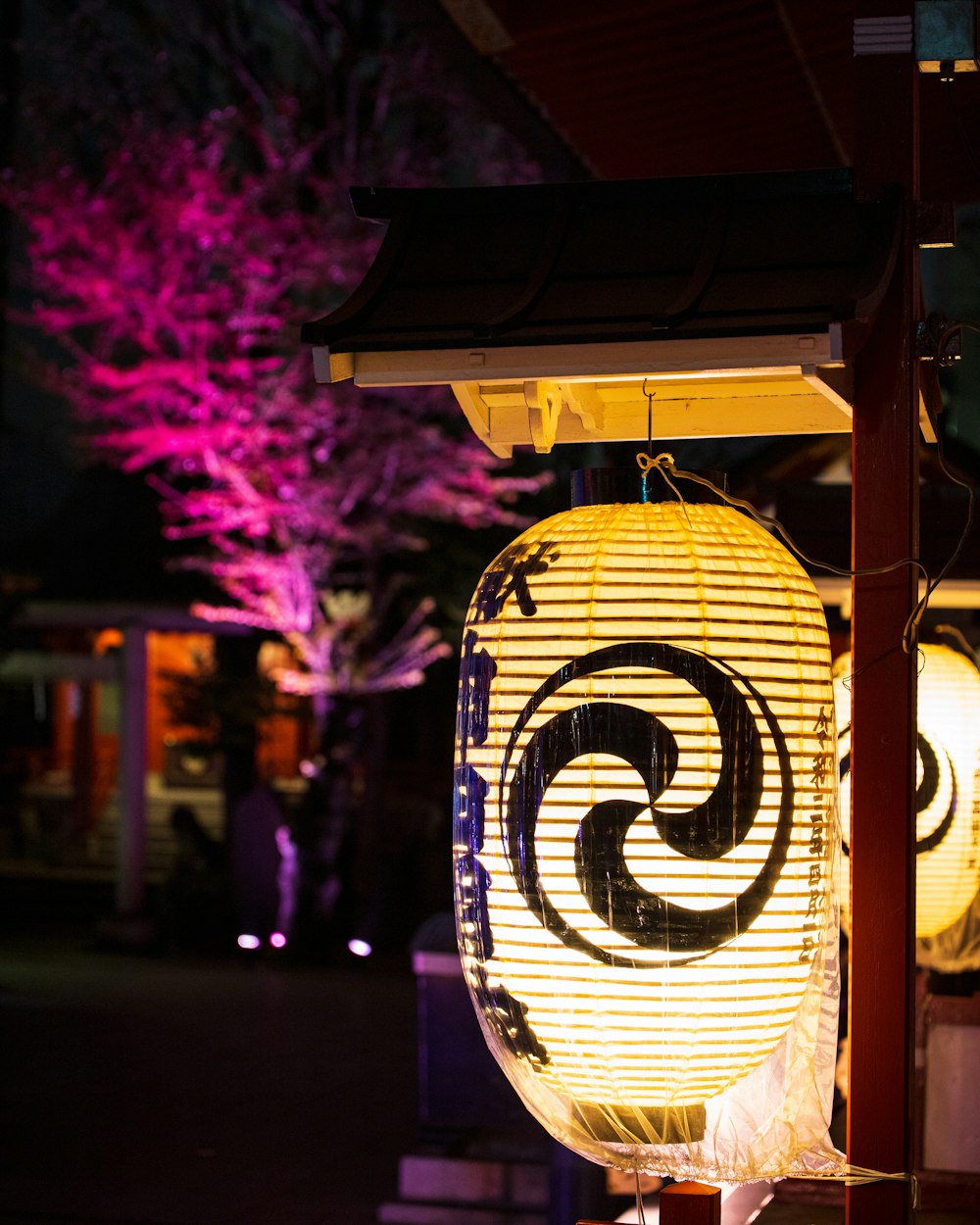 a yellow lantern with a spiral design on it