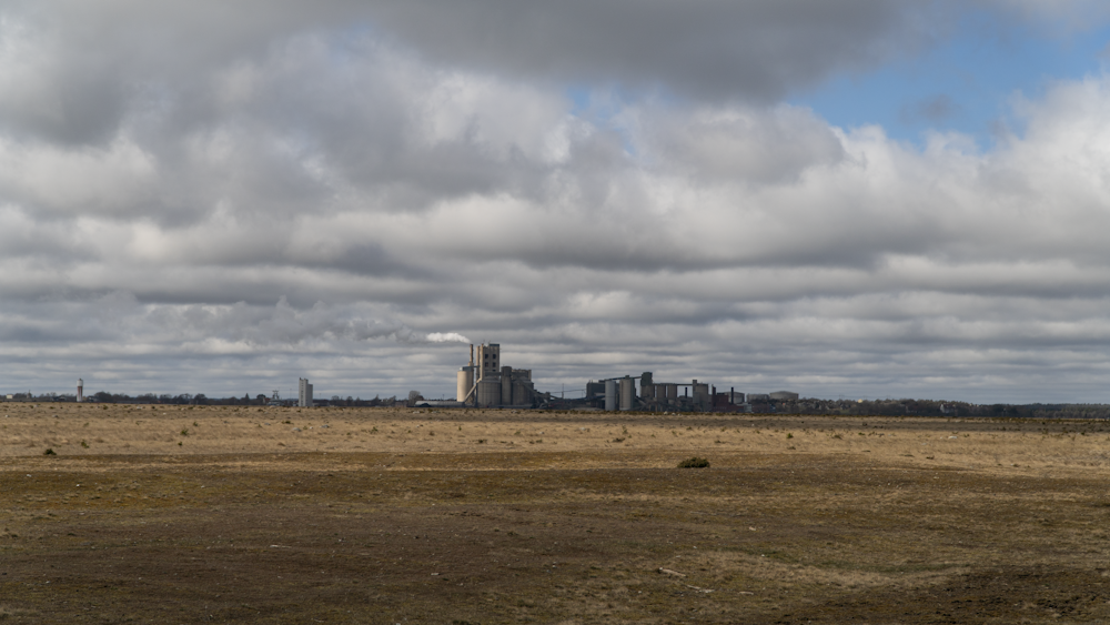 a large field with a building in the distance