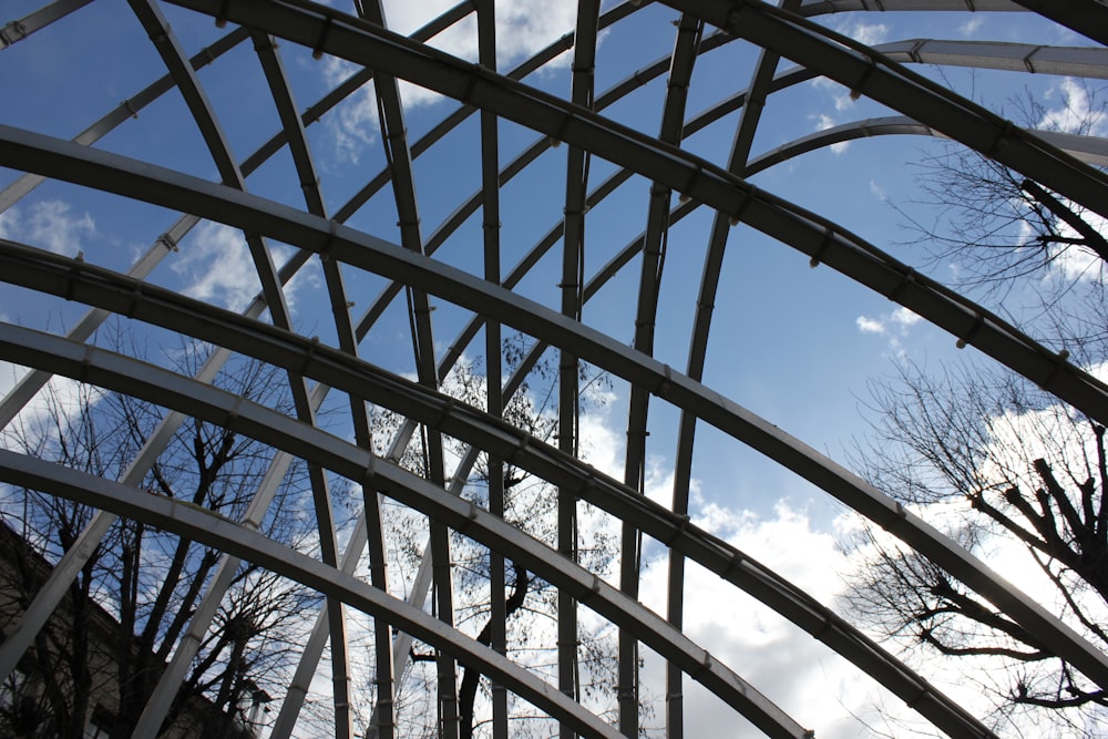 a metal structure with trees in the background