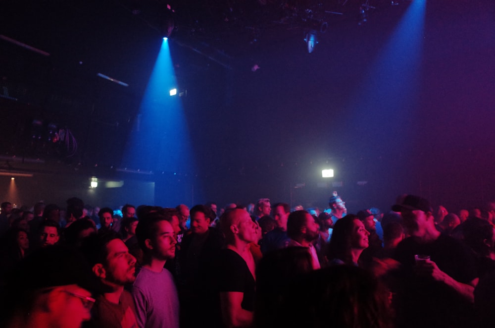 a large group of people in a dark room