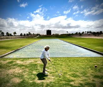 a woman in a white shirt is playing golf