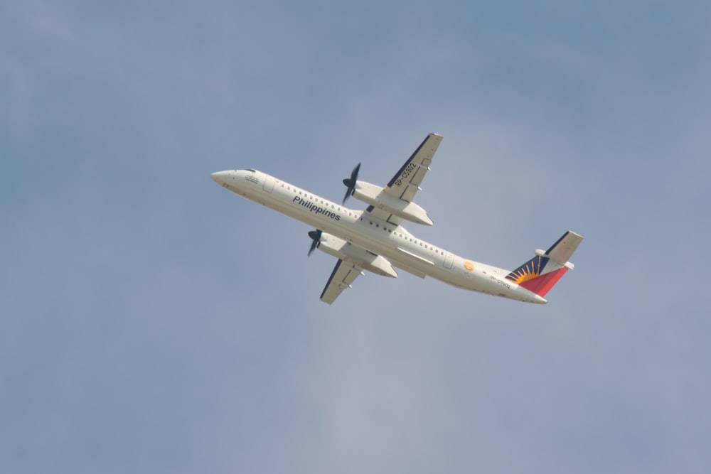 a large jetliner flying through a blue sky