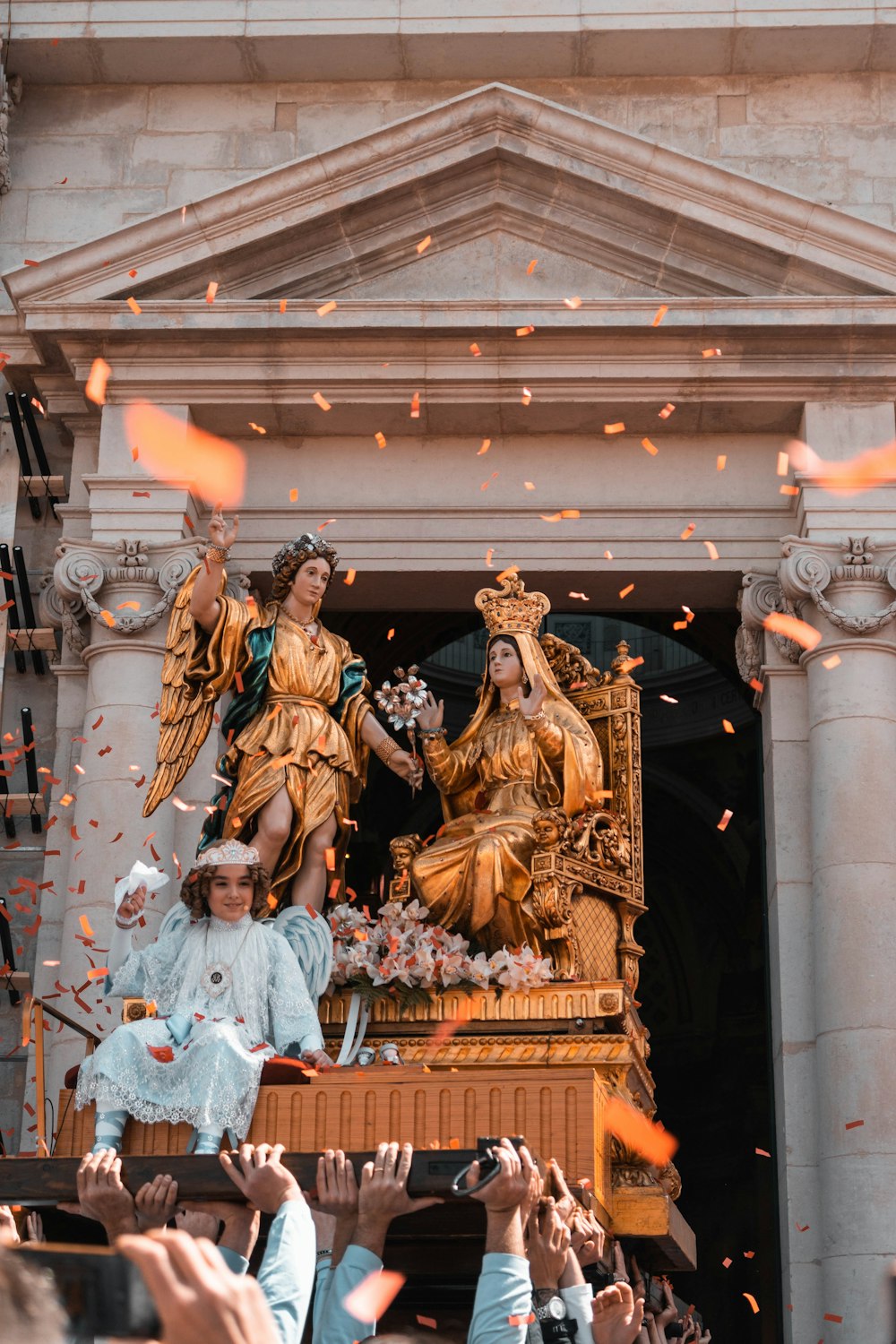 a group of people taking pictures of a statue