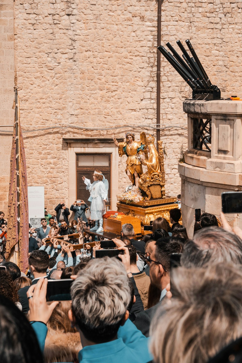 a crowd of people taking pictures of a statue