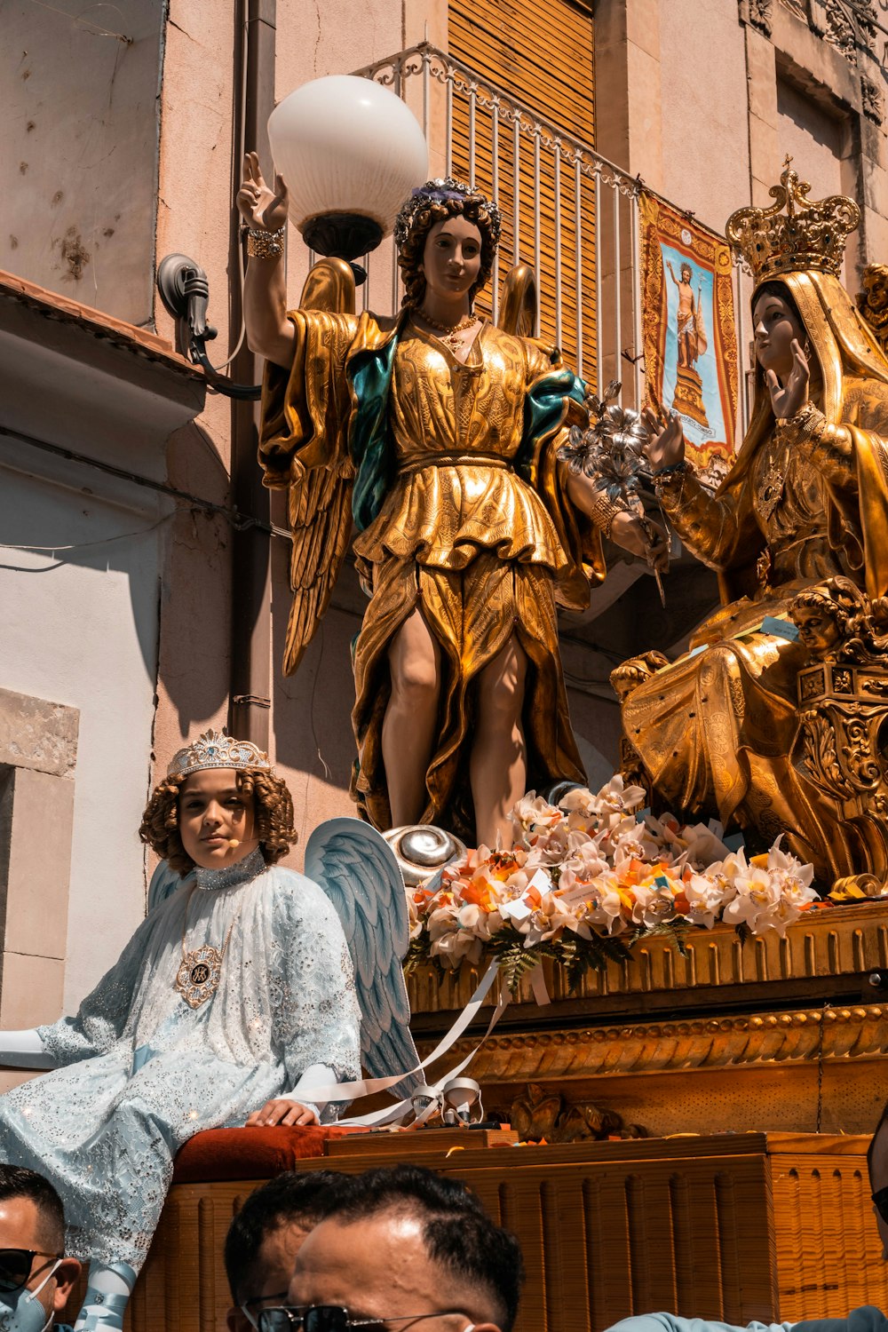 a group of people standing around a golden statue