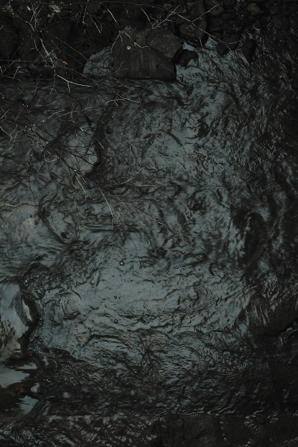 a black and white photo of a stream of water