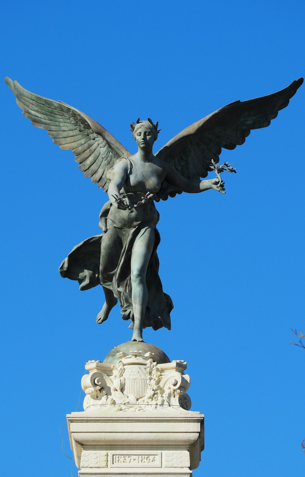 a statue of an angel on top of a building