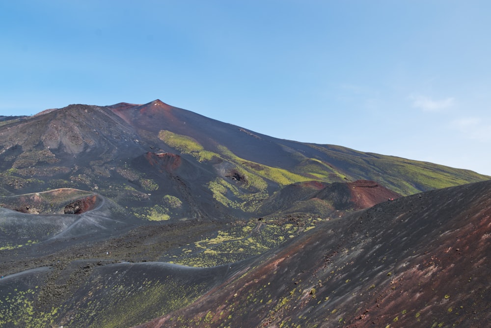 a view of a mountain range with a blue sky in the background