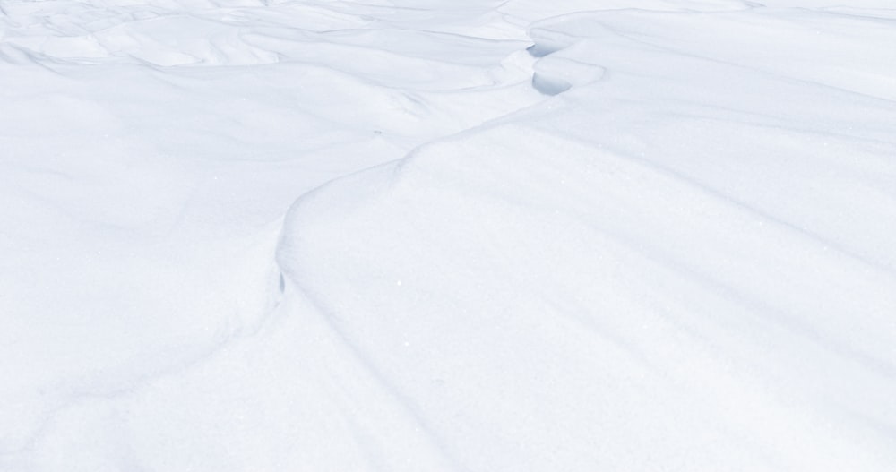 a man riding skis down a snow covered slope