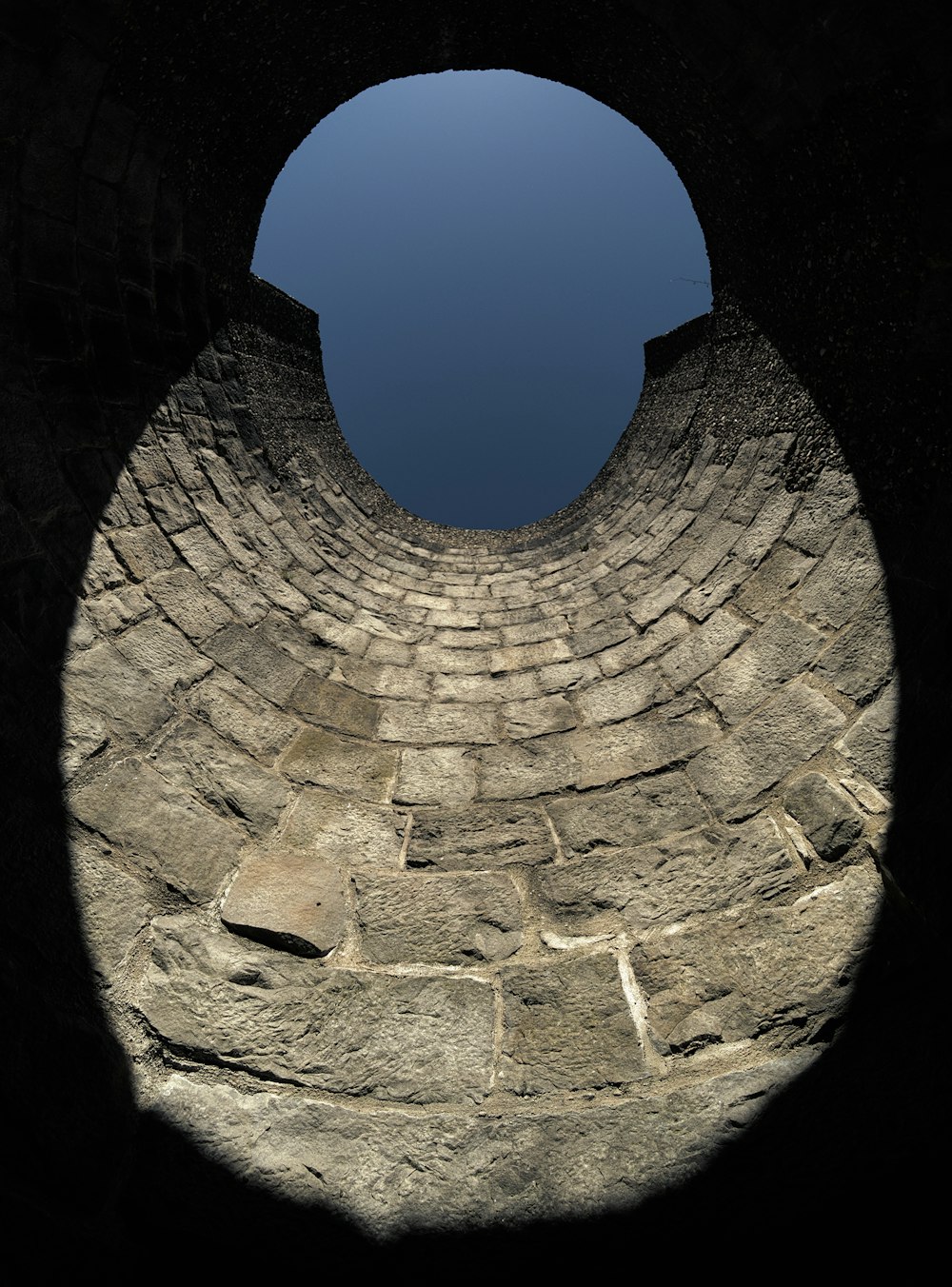 a stone structure with a sky in the background