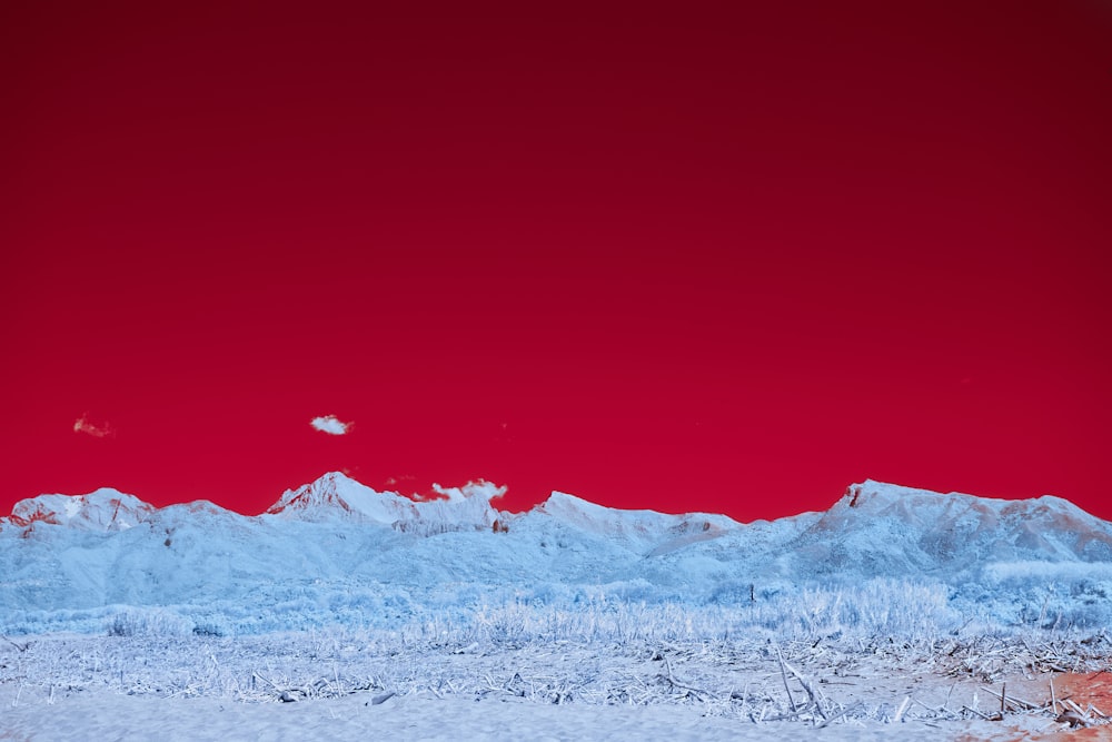 a red sky over a snowy mountain range