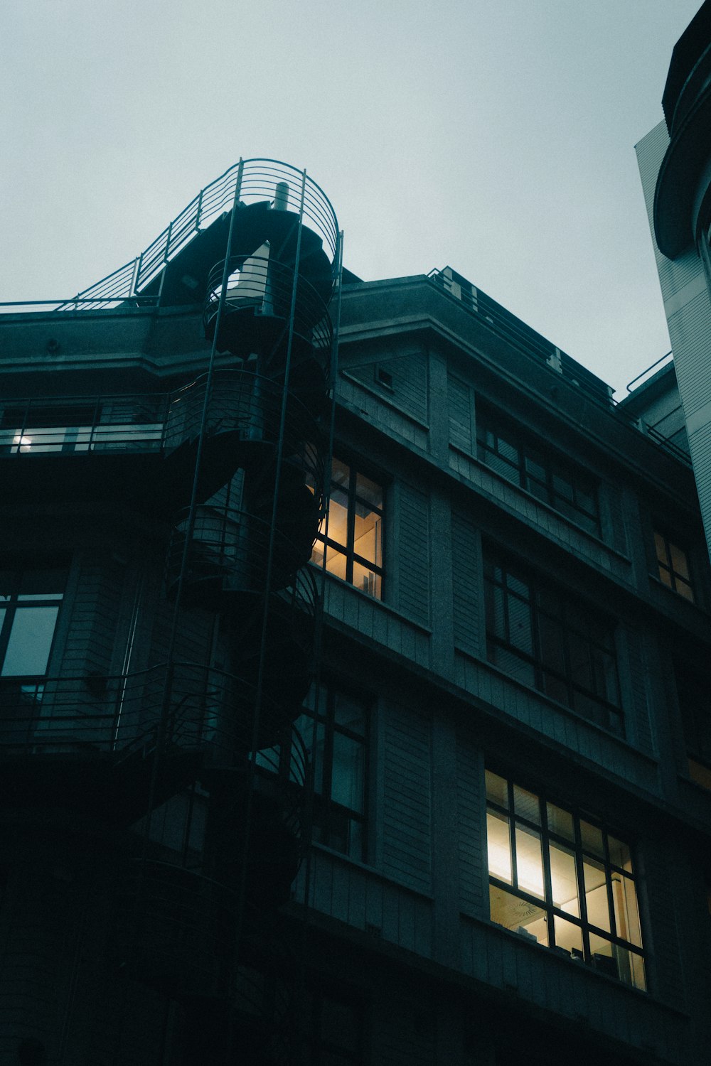 a tall building with a fire escape next to it