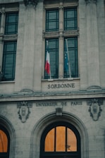 a tall building with a flag on top of it