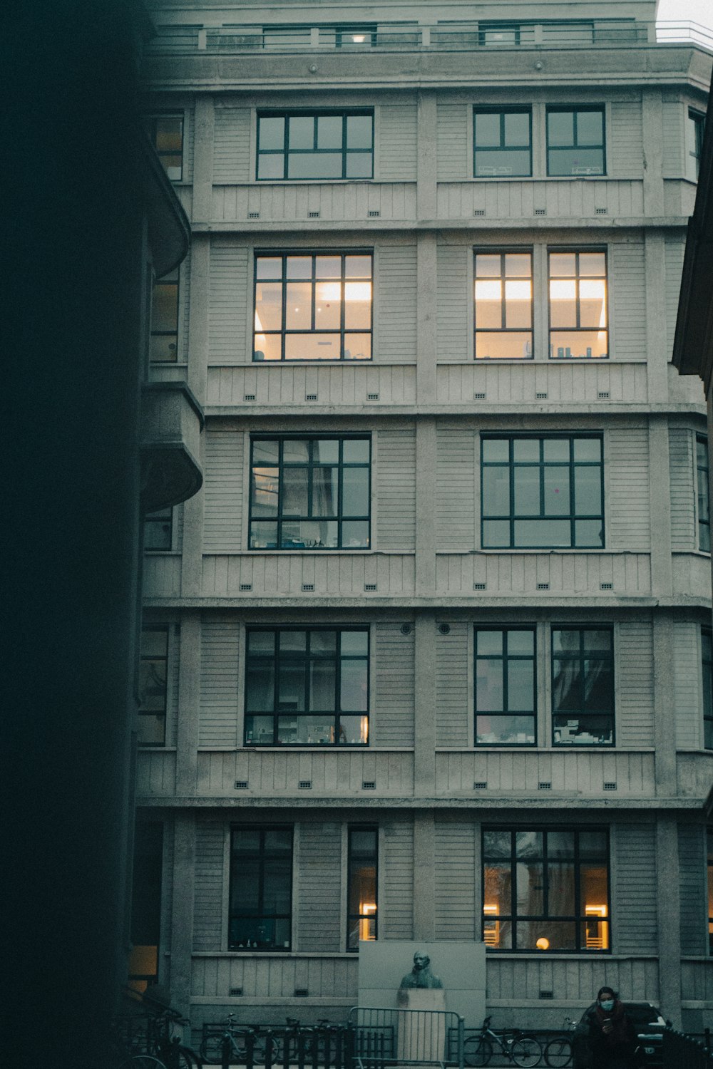 a tall building with lots of windows next to a street