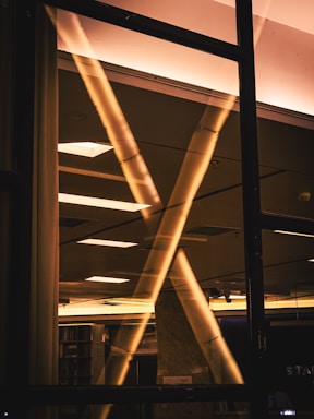 A warmly lit modern workspace with colorful LED linear lighting accents highlighting architectural details