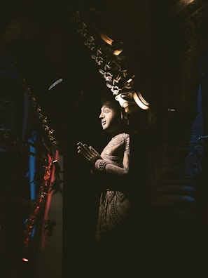 Elegant handcrafted sculpture under soft focused lighting on black background.