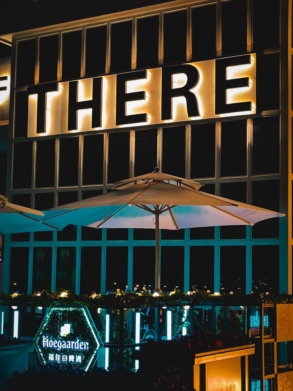 a restaurant with a lit up sign above it