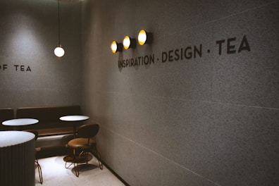 a wall with a sign on it that says design tea