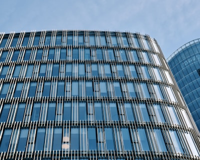 Commercial office space featuring sleek steel and glass facade reflecting cityscape.