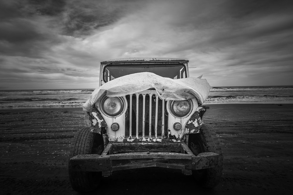 a black and white photo of an old jeep