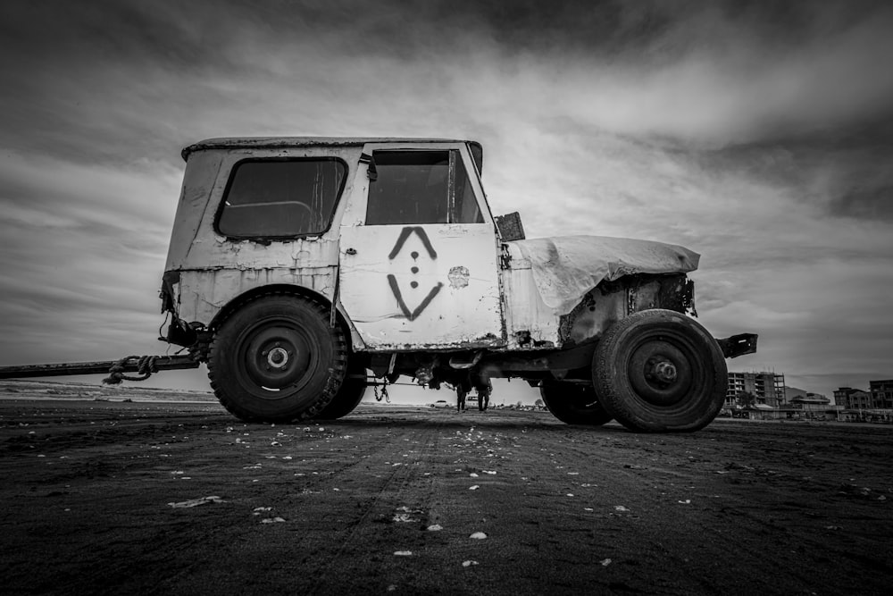 an old truck with a cover on the back of it